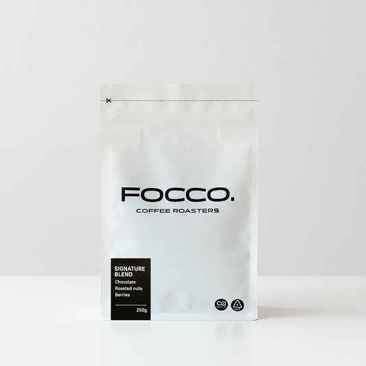 White coffee bag with 'FOCCO Coffee Roasters' branding on a white background and Signature blend black label