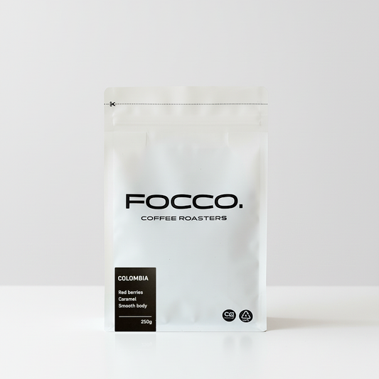 White coffee bag with 'FOCCO Coffee Roasters' branding on a white background and Colombia black label