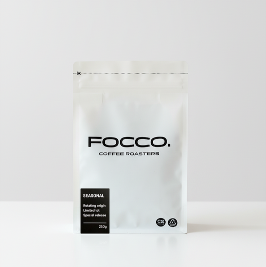 White coffee bag with 'FOCCO Coffee Roasters' branding on a white background and Seasonal black label